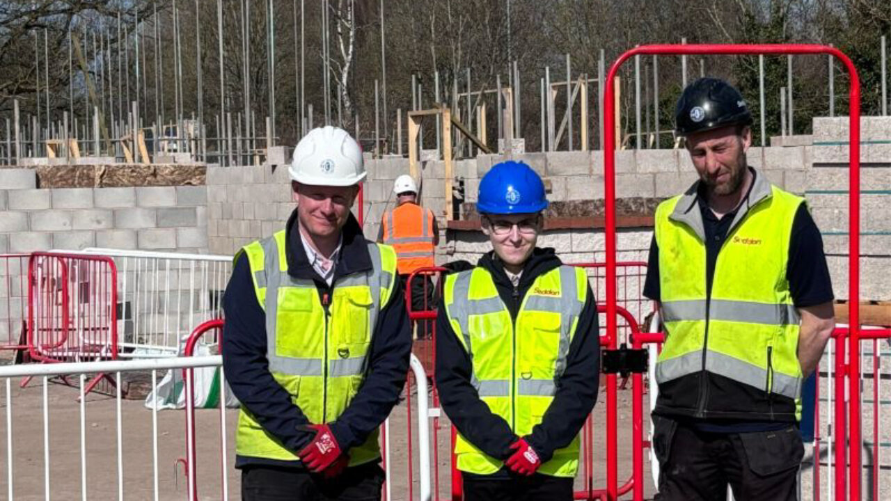 Aaron alongside Seddon Construction representatives on a construction site.