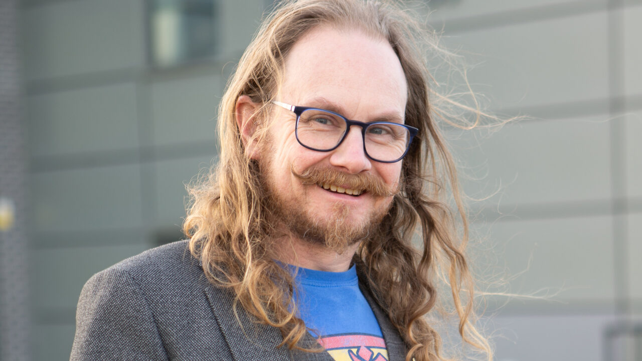 Mechatronics and Engineering lecturer Craig Melville, standing in front of Technology Hub Building at Stoke on Trent College's Burslem campus.