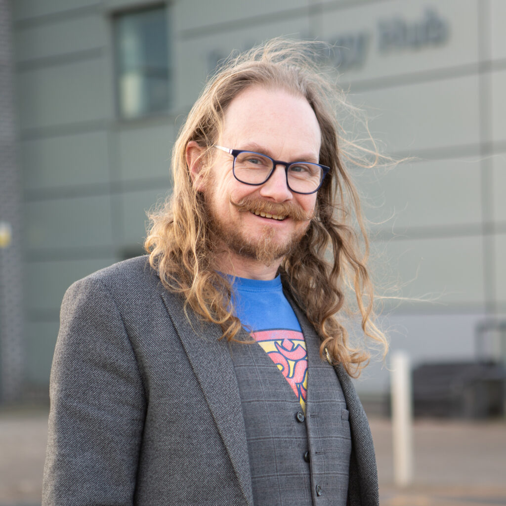 Mechatronics and Engineering lecturer Craig Melville, standing in front of Technology Hub Building at Stoke on Trent College's Burslem campus.