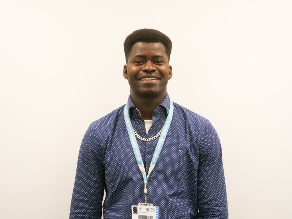 Stoke on Trent College Level 1 ESOL student Sekou Sidibe, standing against blank background.