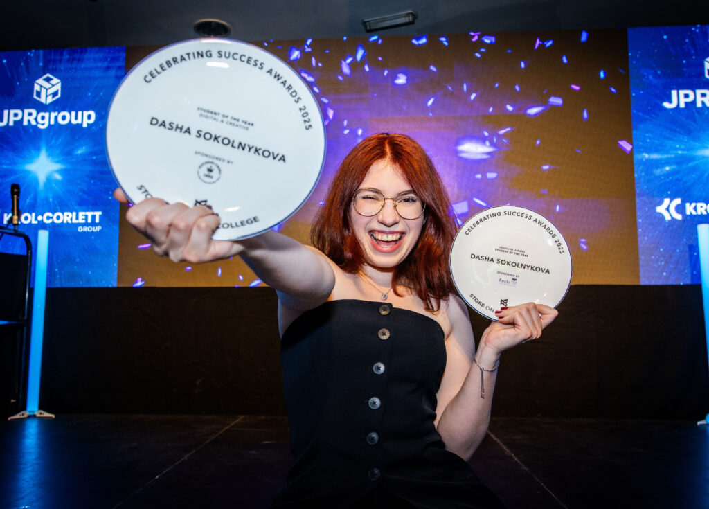 Celebrating Success 2025 Student of the Year, Dasha Sokolynkova, standing on a stage with two awards, smiling.