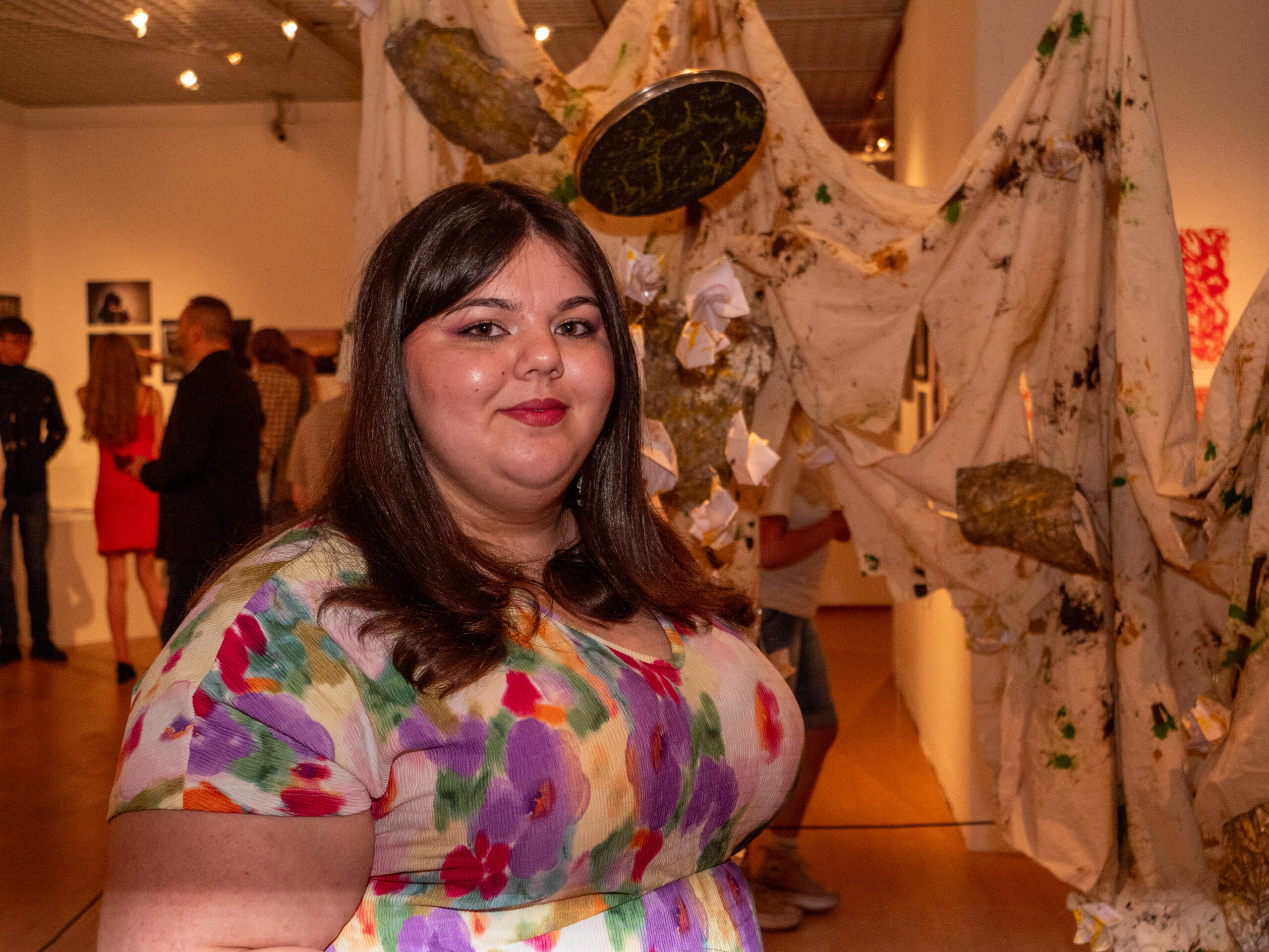 Student in front of artwork.
