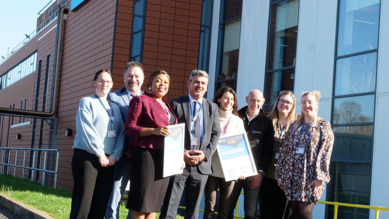 Stoke on Trent College staff and Skills Pledge partners stand with their awards outside the Lifestyle Building at Cauldon Campus