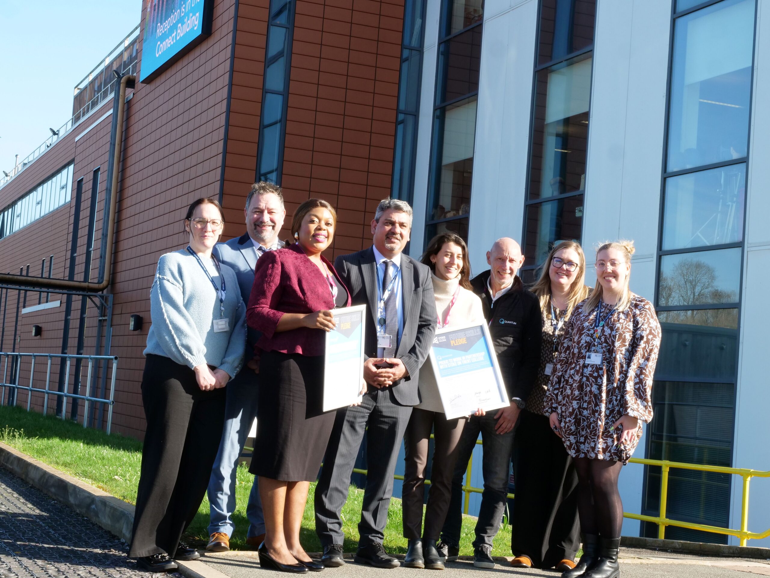 Stoke on Trent College staff and Skills Pledge partners stand with their awards outside the Lifestyle Building at Cauldon Campus